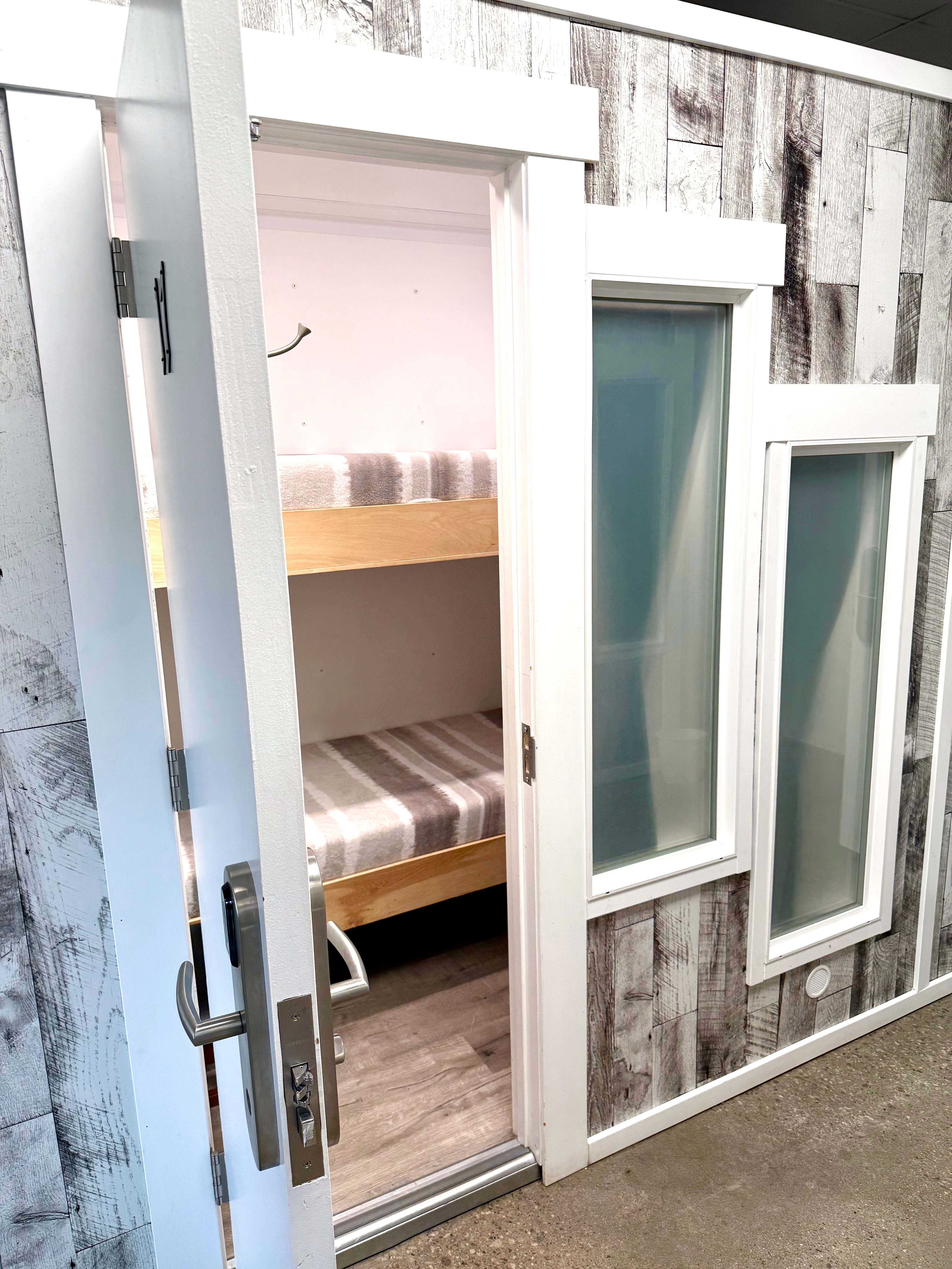 A clean, modern sleeping pod at Cohabit.